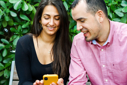 Two people looking into phone