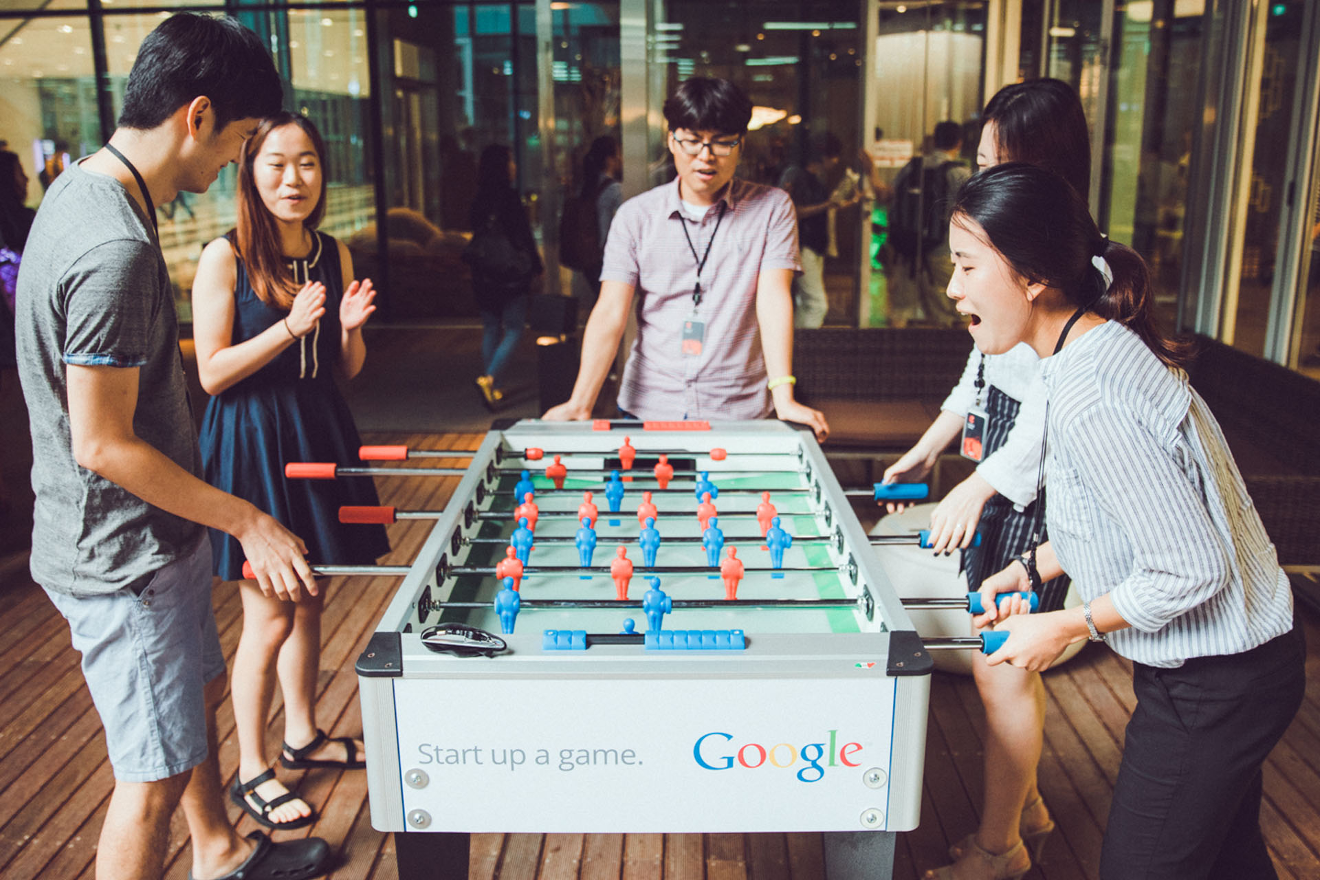 A group of colleagues playing foosball